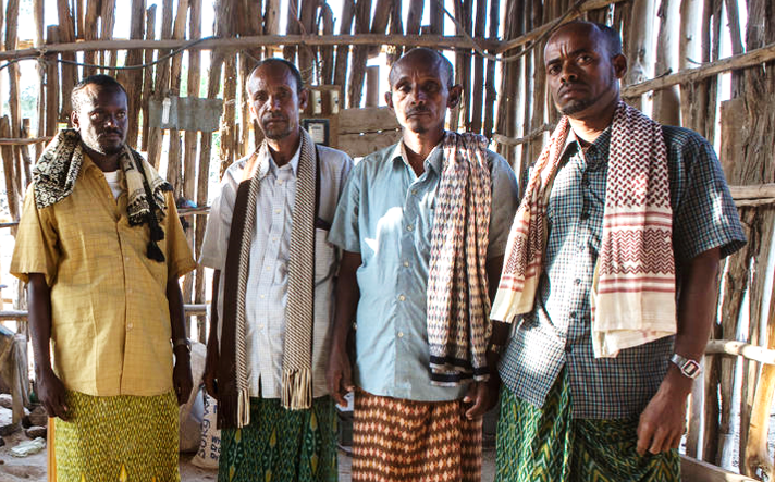 Four men standing next to each other looking at the camera, Ethiopia.