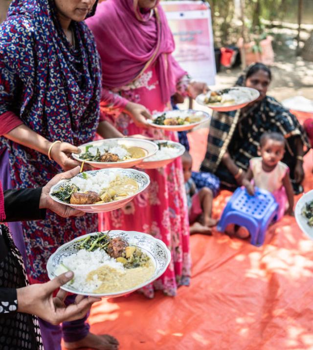 photo of women holding plates of food