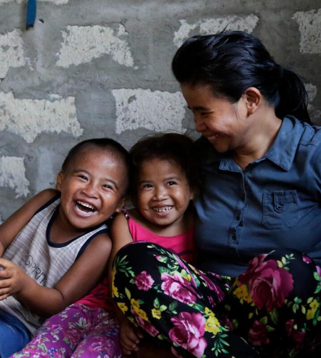 photo of woman smiling with children