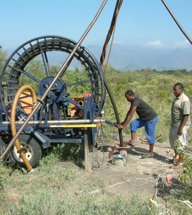 Two men are operating a machine