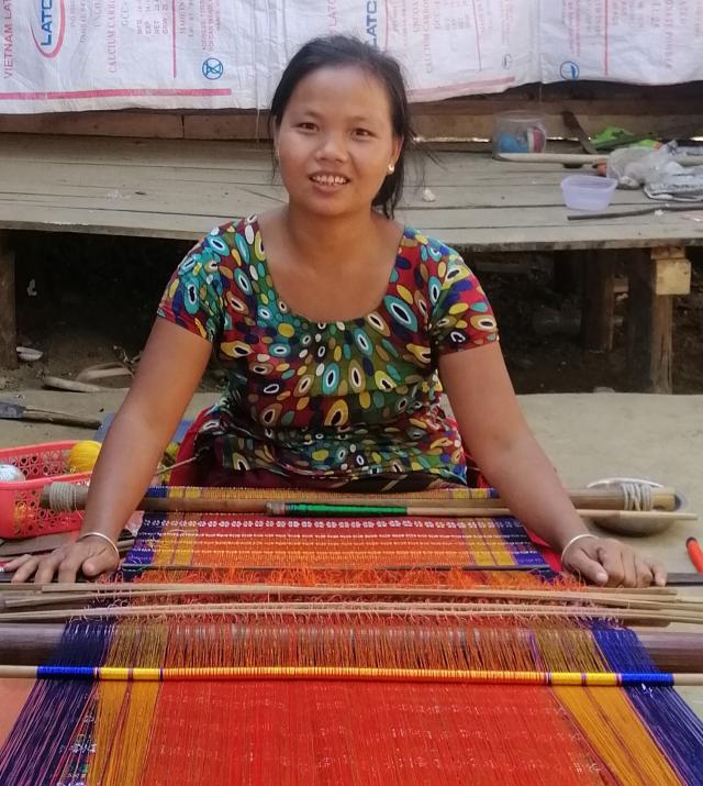 Woman producing woven product