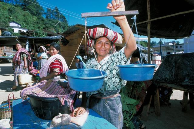photo of woman smiling at a market
