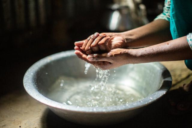 photo of woman washing her hands