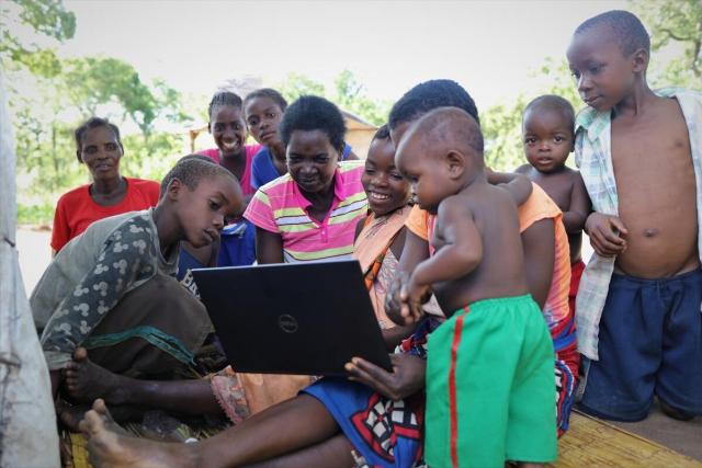photo of a family using a laptop