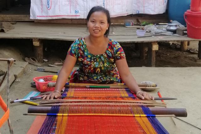Woman producing woven product